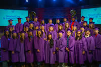 LearningQuest graduates in purple gowns and caps
