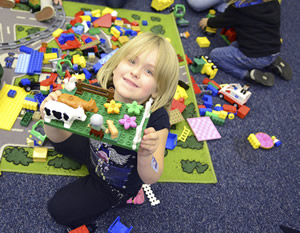 Child with lego structure at the library